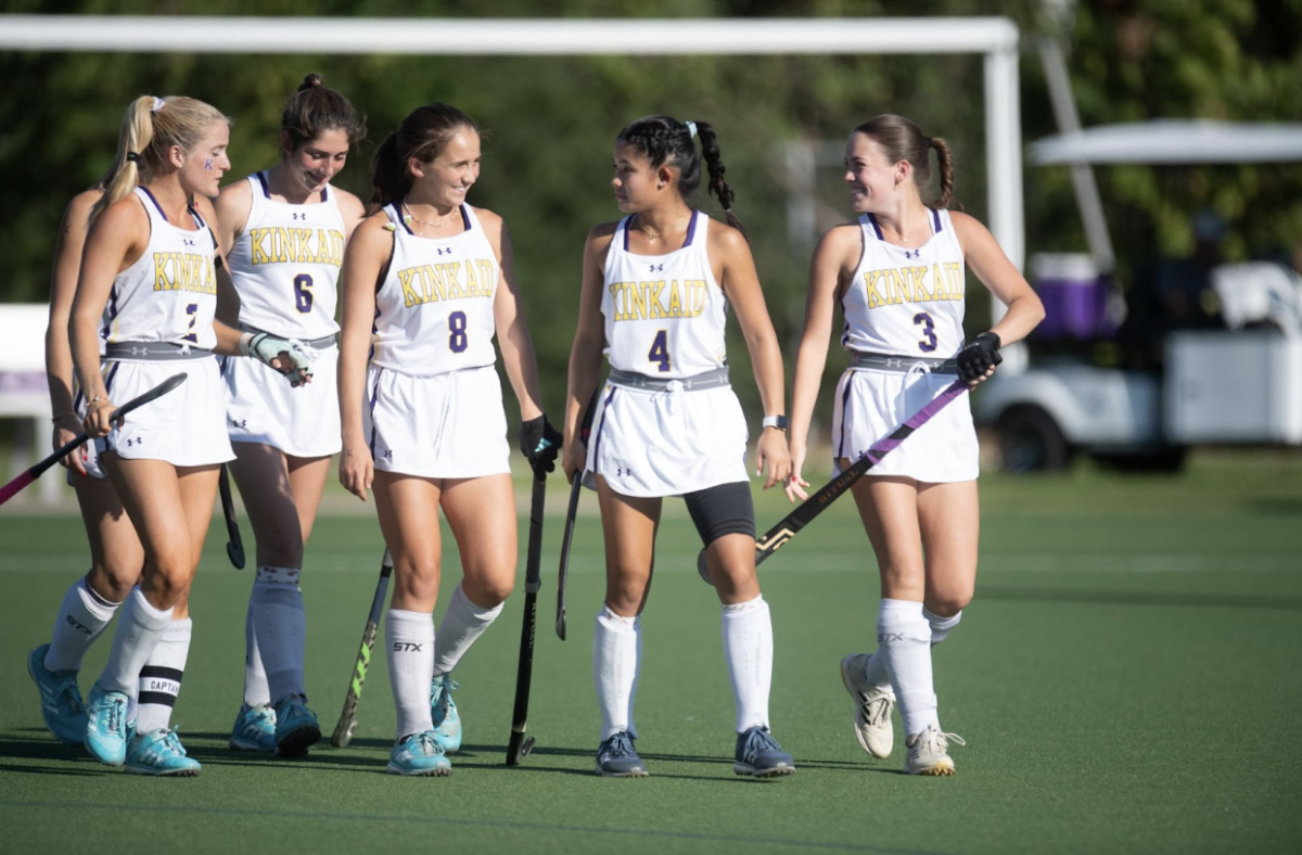 Kinkaid field hockey players Caroline Raynes, Nina Piazza, Ella Ou, Grace Essalih, and Harper Brown taking the field in all smiles ready to take on the St. Johns Mavericks.